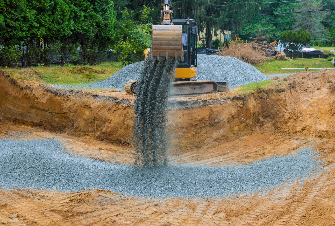 excavator-wheel-backfilling-foundation-building-1206237